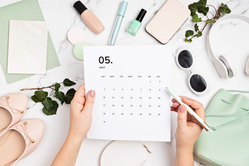 Flat lay with calendar for may with woman fashion spring accessories. Social media blog, schedule, planning concept. Flatlay, top view